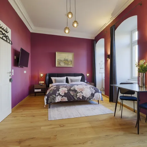 Das gemütliche Tapferes Schneiderlein Zimmer mit Bett, kleinem Esstisch und Küche in den Grimms Schlossapartments.